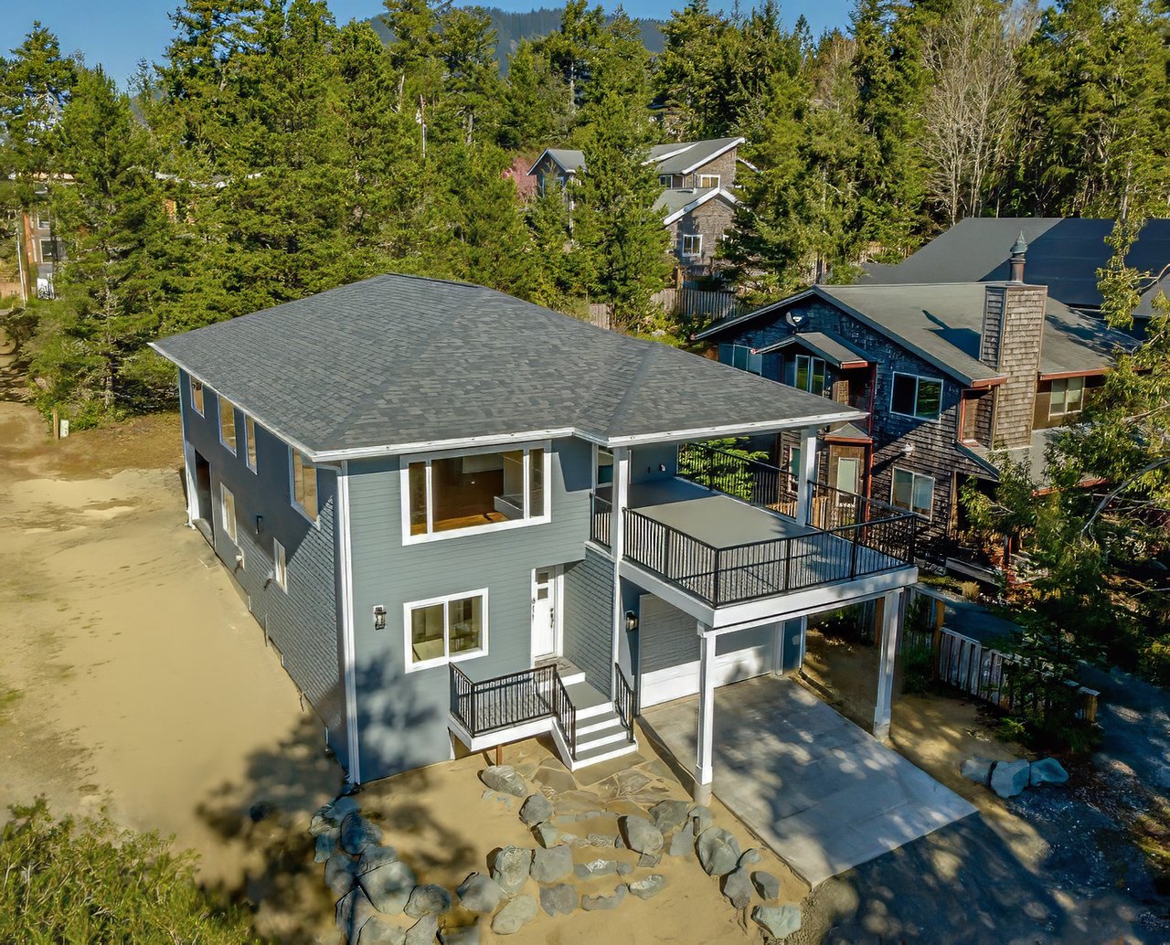 Sold custom home at 811 Oak St in Manzanita, Oregon, represented by Meadow Davis of Home + Sea Realty, with modern coastal finishes and smart home features.