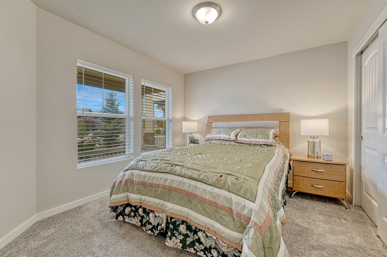 Main-level bedroom with two windows