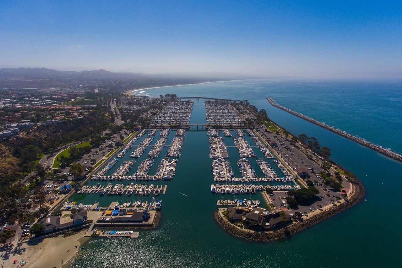 Dana Point Harbor with luxury boats and waterfront, coastal California lifestyle