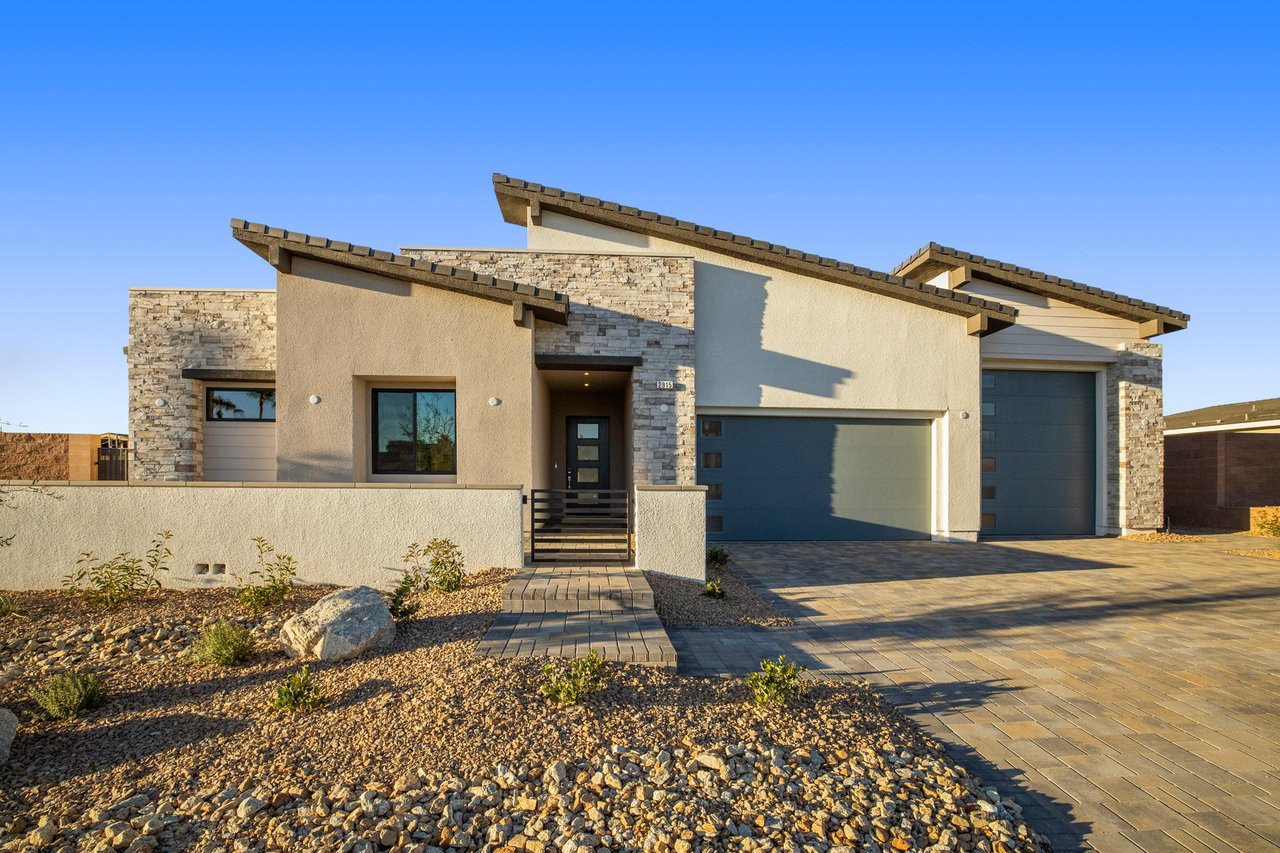 Modern Las Vegas home with angular rooflines, stone accents, and desert-rock landscaping.