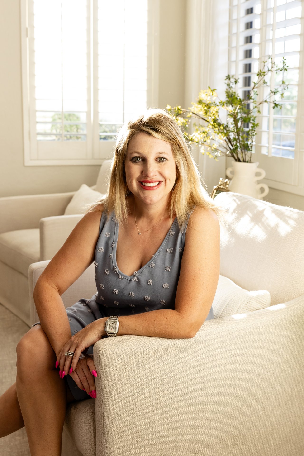 Rachel Kohn, Scottsdale Realtor, seated in a bright living room, helping buyers and sellers in North Scottsdale.