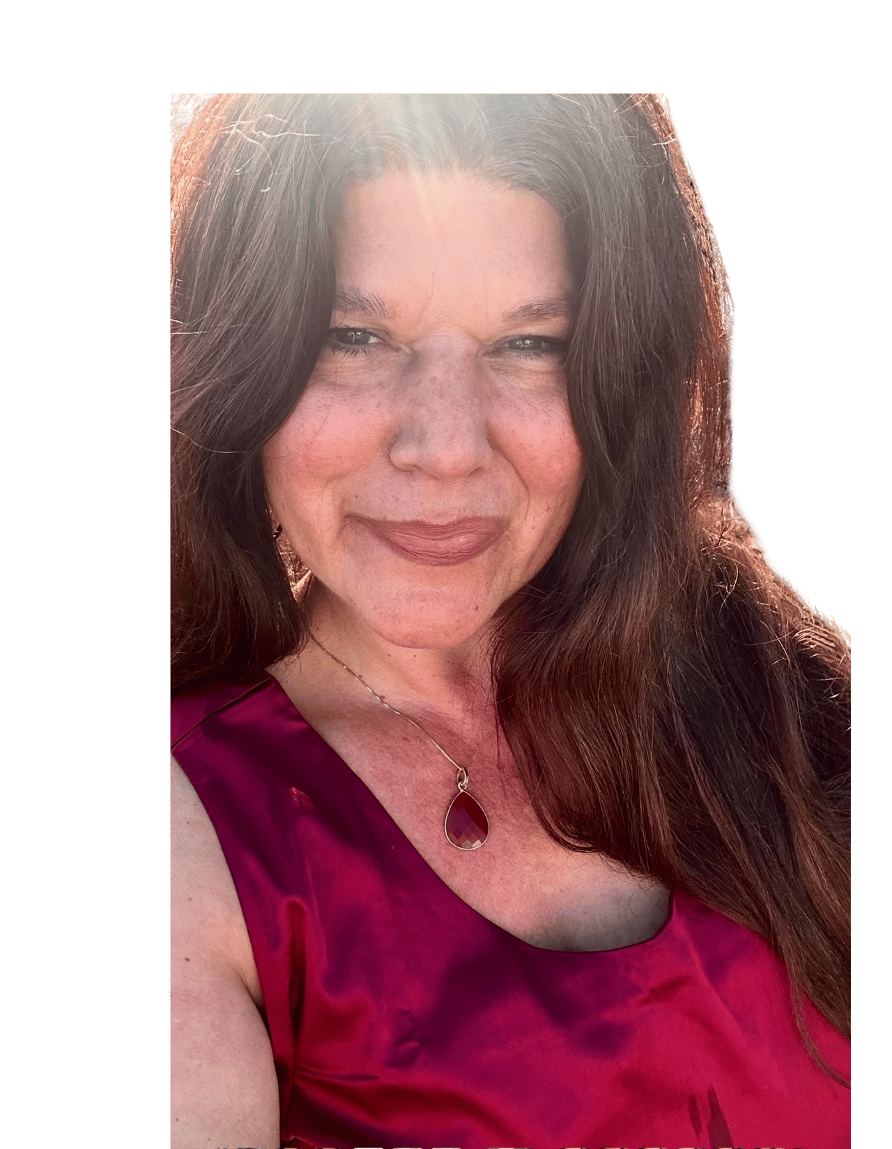 Adria Avilla smiling in a magenta top and pendant necklace.