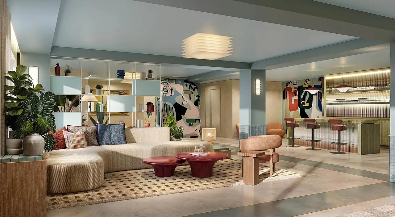 Duos Wynwood lounge with a large sectional sofa and a bar lined with stools.