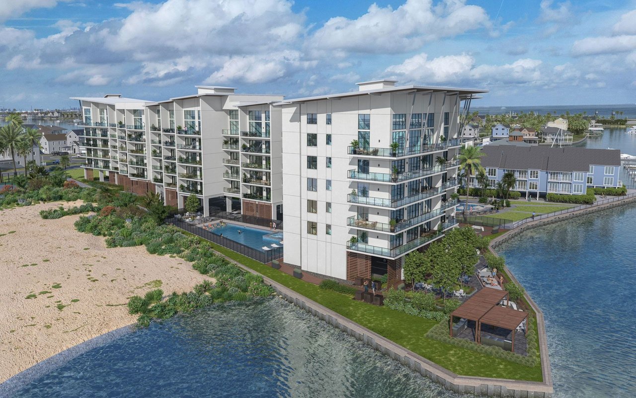 The Residences at Tiki Island, a modern waterfront condominium complex with balconies and a pool.
