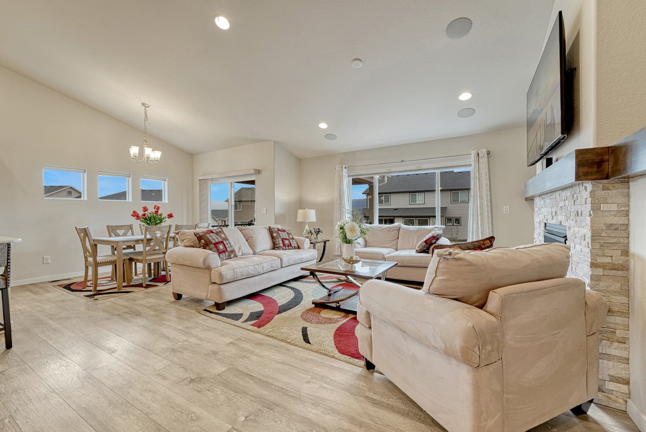 Living room looking toward the dining area under a vaulted ceiling