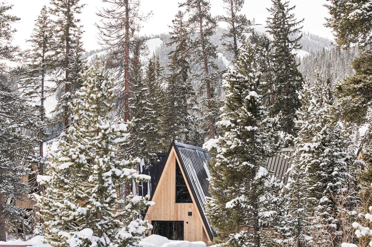 Snowy exterior of an A-Frame Club cabin in Winter Park, Colorado with mountain-lodge design