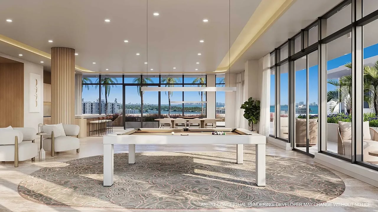 Billiards lounge with a white pool table, floor-to-ceiling windows, and water views.