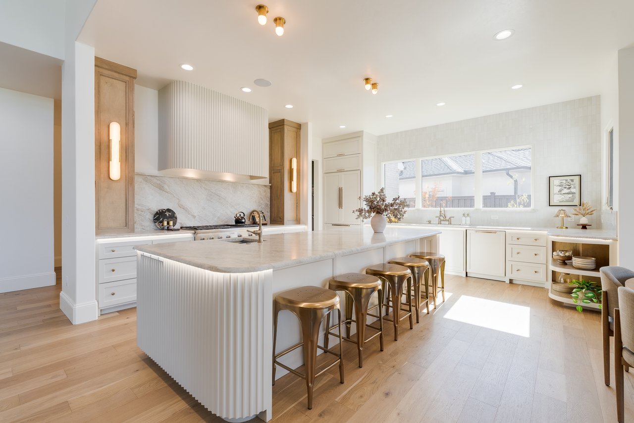 pacious gourmet kitchen with marble countertops, designer lighting, and seasonal styling in an Edmond luxury home.