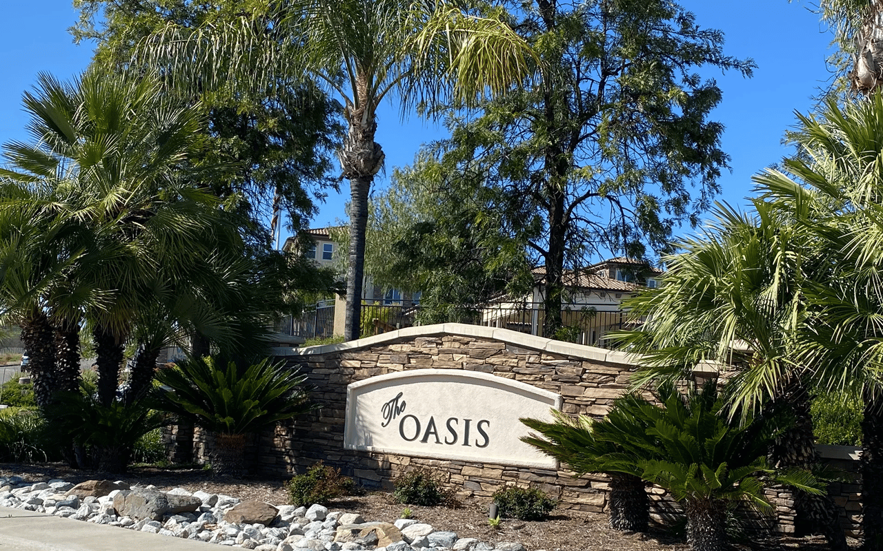 The entrance sign for Oasis, a highly sought-after 55+ active adult golf community in Menifee, California.