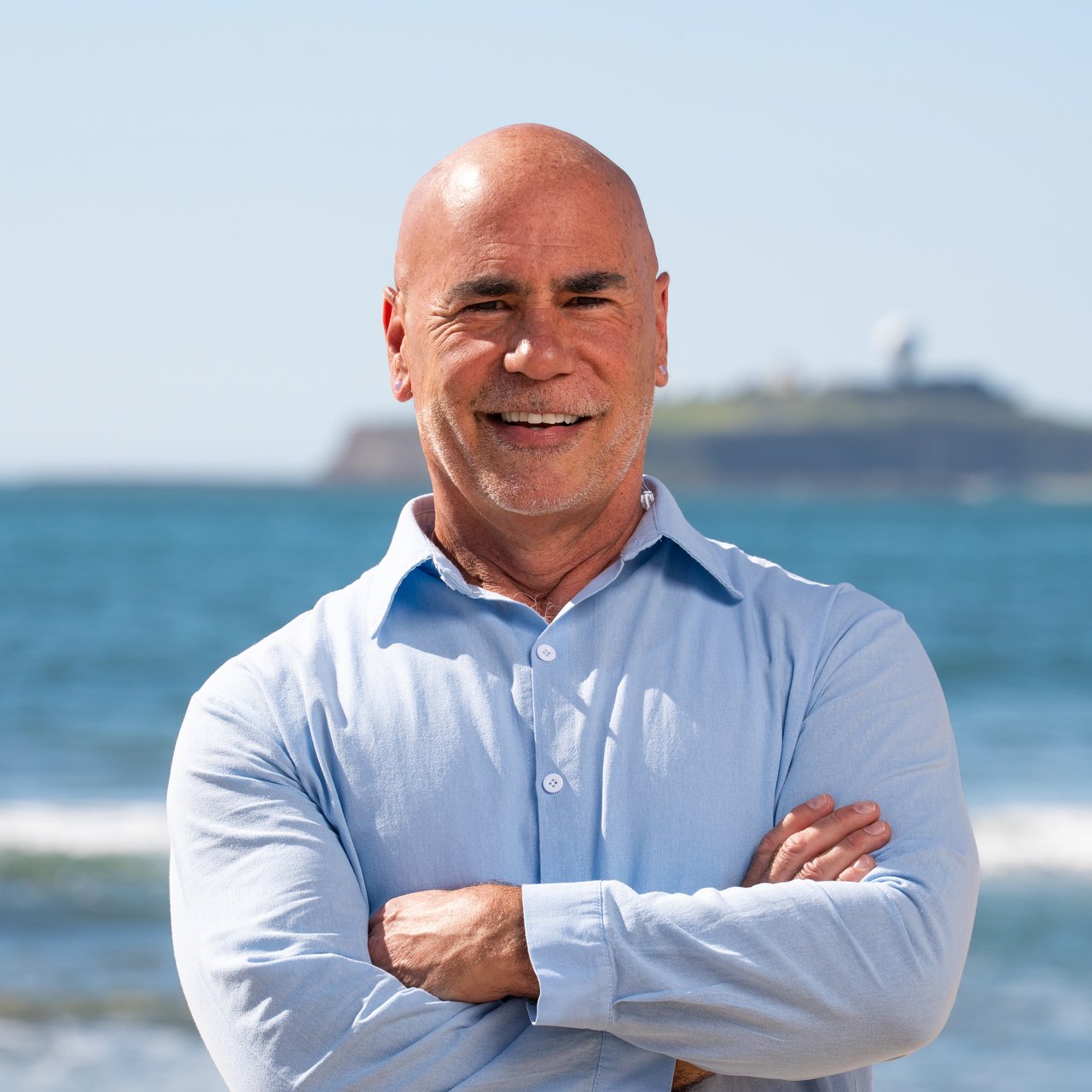 David Oliphant, Half Moon Bay real estate agent, co-founder of Ocean Element Real Estate, standing on a Coastside beach with ocean views in San Mateo County