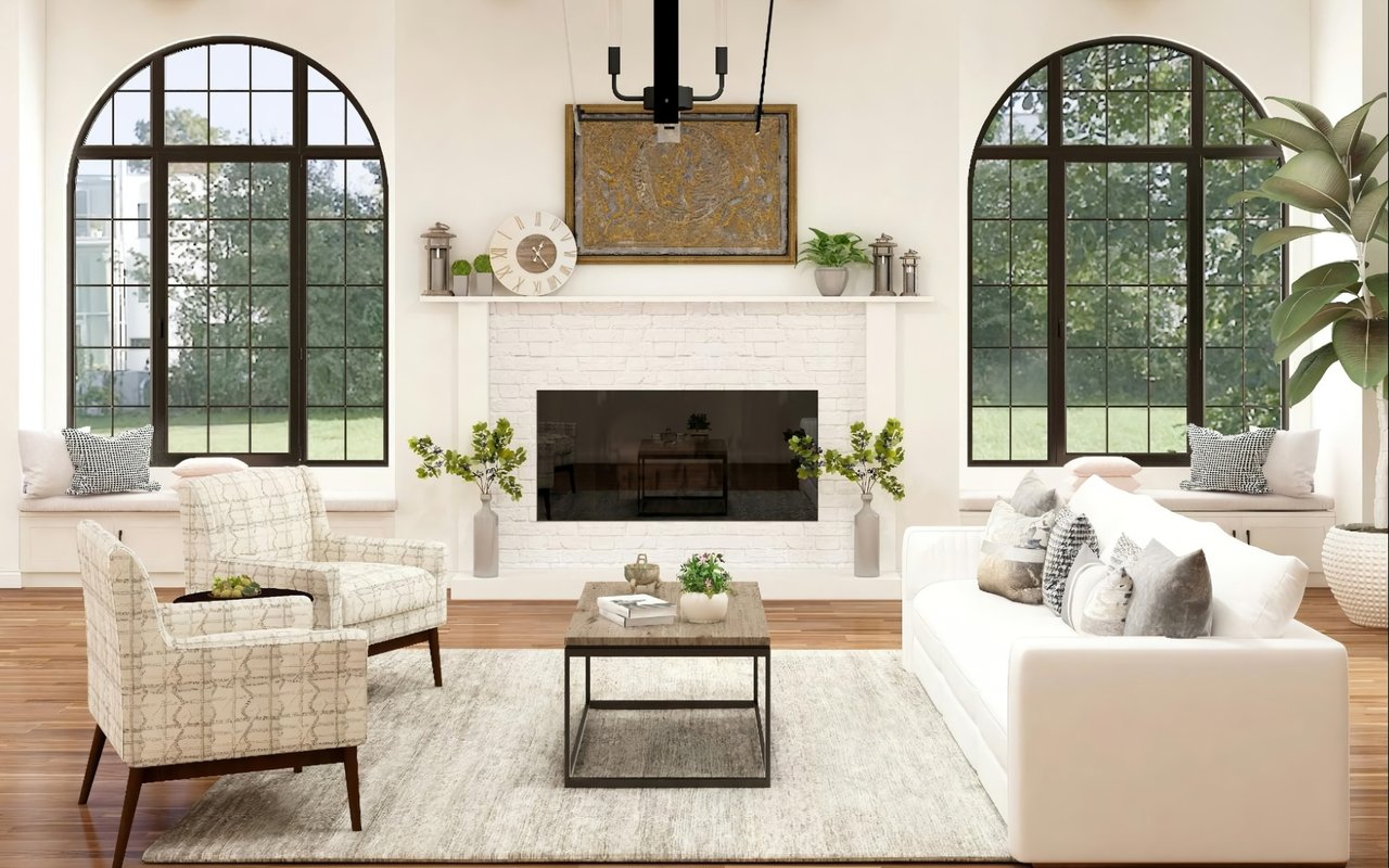  A brightly lit living room features a white sofa, two armchairs with a light geometric pattern, and a light-colored rug on a wooden floor.