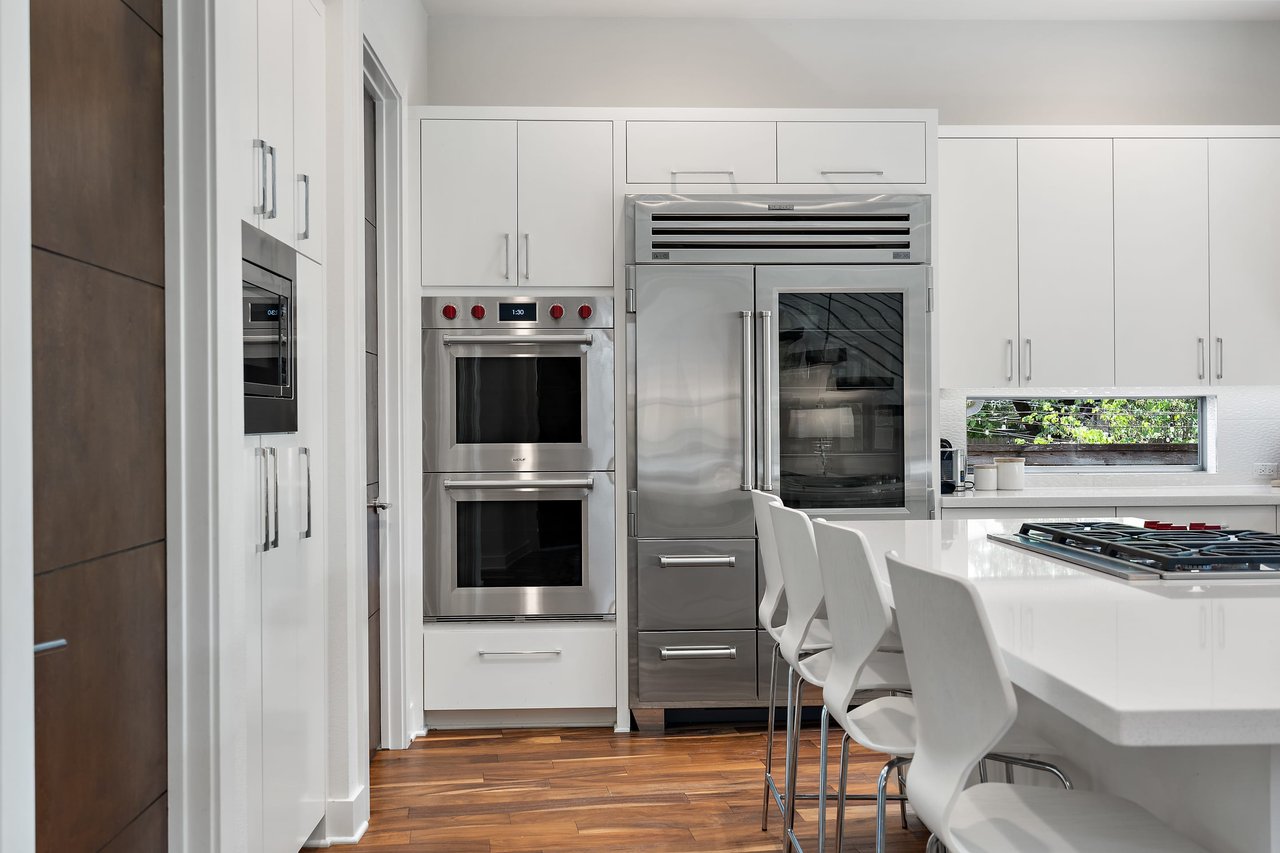 Kitchen with double ovens and island seating at 34 Margranita Crescent, Tarrytown, Austin, TX.