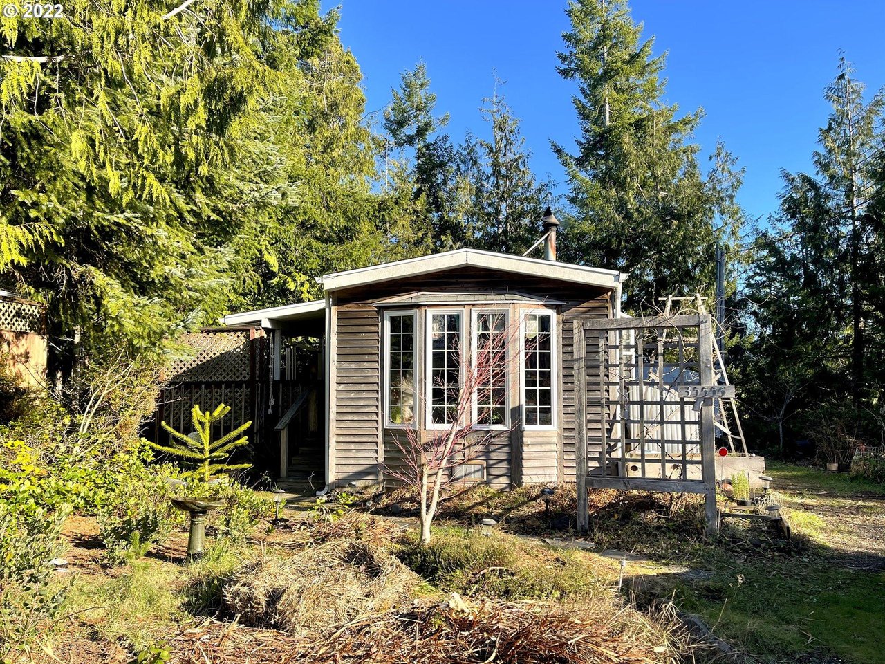 Sold Nehalem home at 35555 Sea Forest Way represented by Erin Laskey of Home + Sea Realty with greenhouse and oversized lot near Manzanita Beach