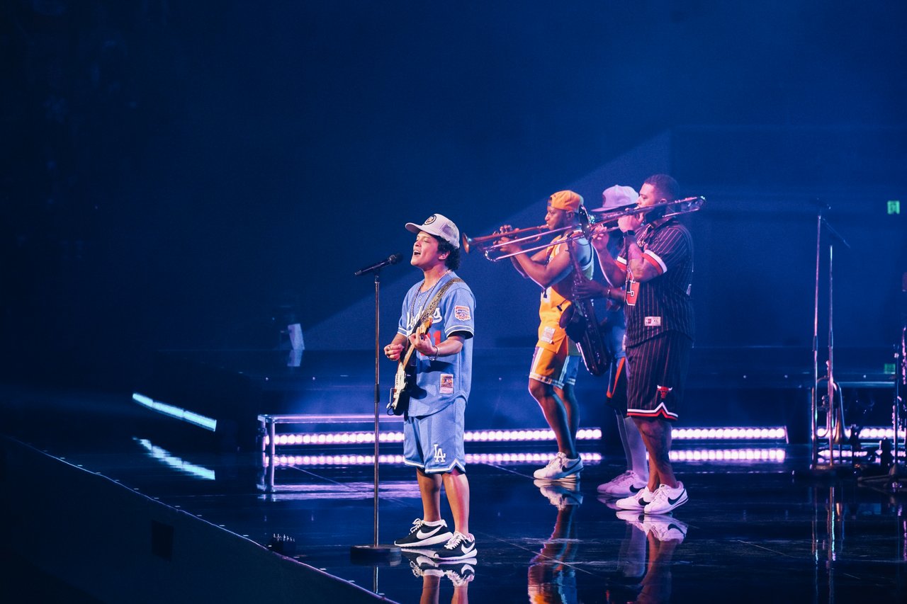 Bruno Mars performing live with musicians on stage