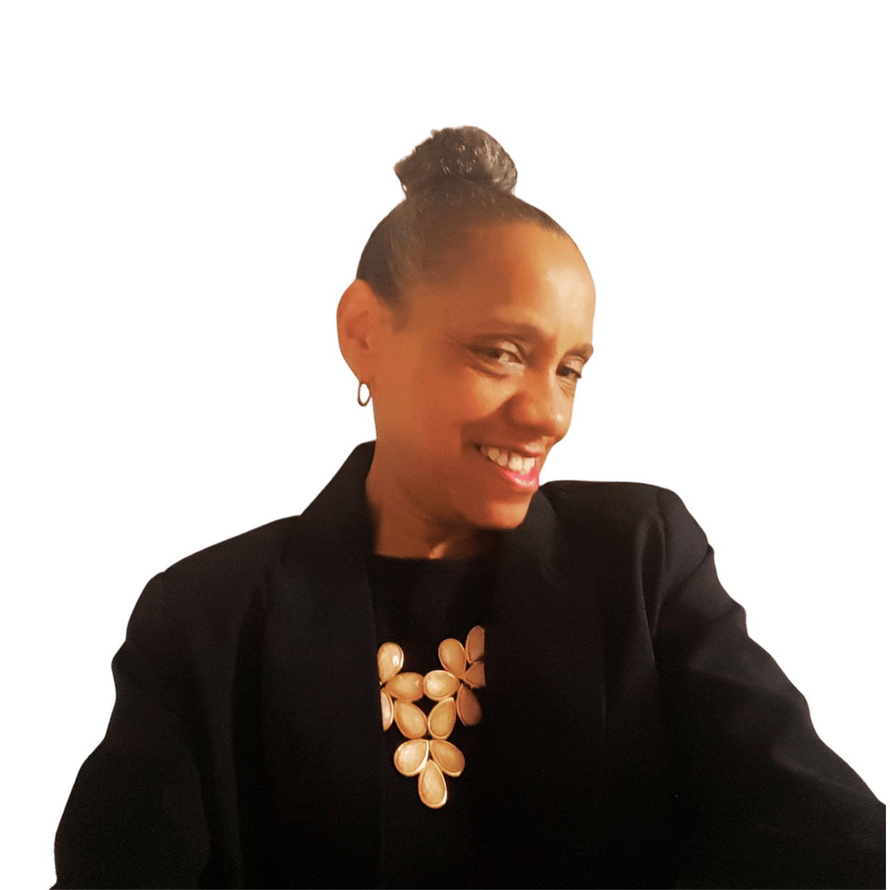 Roberta Allen smiling in a black jacket with a large gold-toned floral necklace.