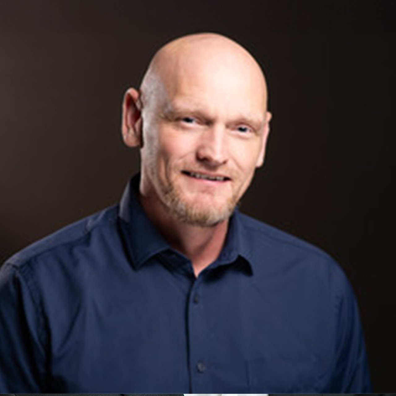 Professional headshot of Brent Thomas, smiling and dressed in business attire, for use on his real estate bio page.