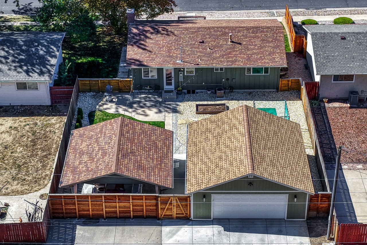 Aerial view of the lot showing the house, covered patio, yard and detached garage