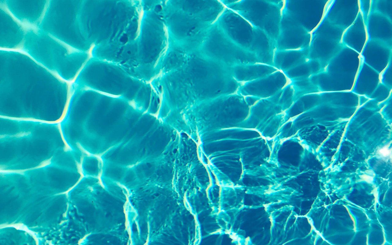 Sunlight ripples across turquoise water.