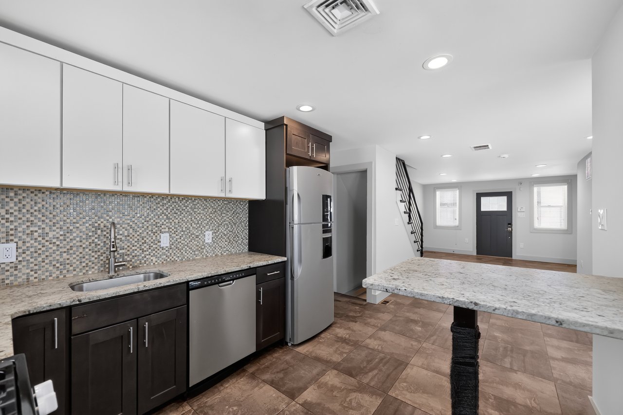 Renovated kitchen with granite countertops and stainless steel appliances at 2116 S. Beechwood Street in South Philadelphia