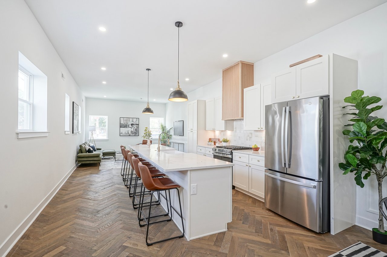 Modern Philadelphia kitchen with white cabinets, island seating, and hardwood floors