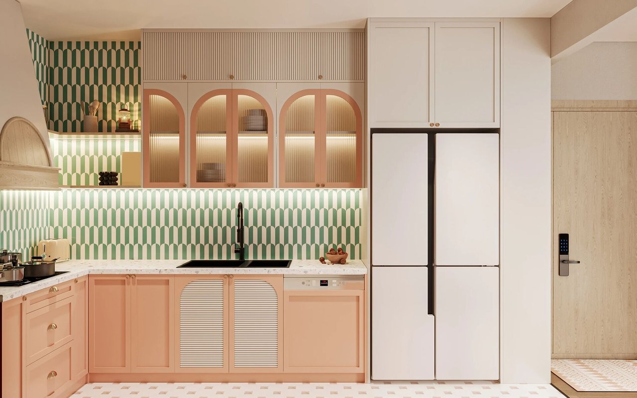 Modern kitchen with peach cabinets, arched glass-front cupboards, and green-and-white patterned tile.