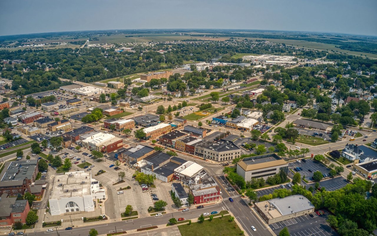 Aerial view of Ankeny’s downtown buildings, tree-lined streets, and surrounding farmland.