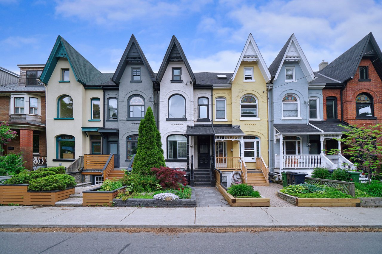 Colorful row houses with steep gables, arched windows, and landscaped front gardens.