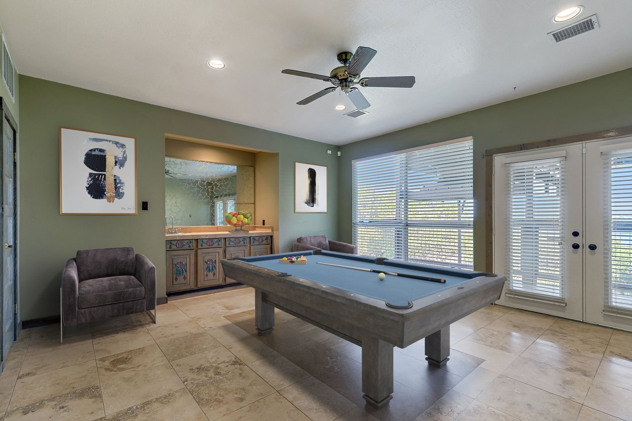 Game room with a billiards table, wet bar, and French doors at 12709 Cedar St, Austin, TX 78732 (Hughes Park Lake).