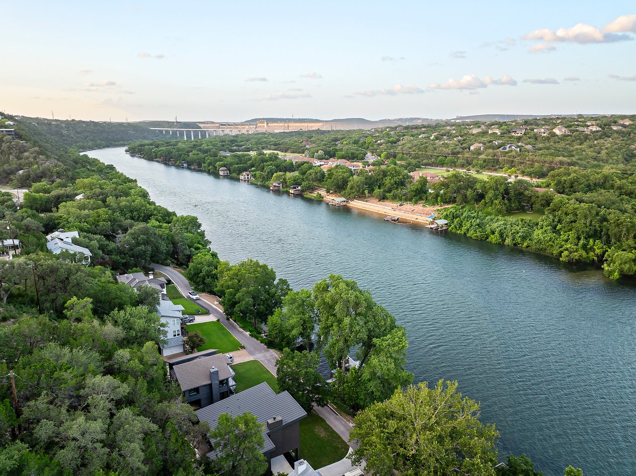 Aerial view of the Lake Austin shoreline and wooded hills near 2403 Big Horn Drive, Austin.