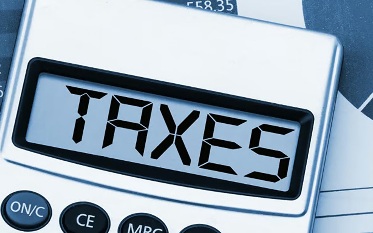 Calculator displaying “TAXES” over a financial form.
