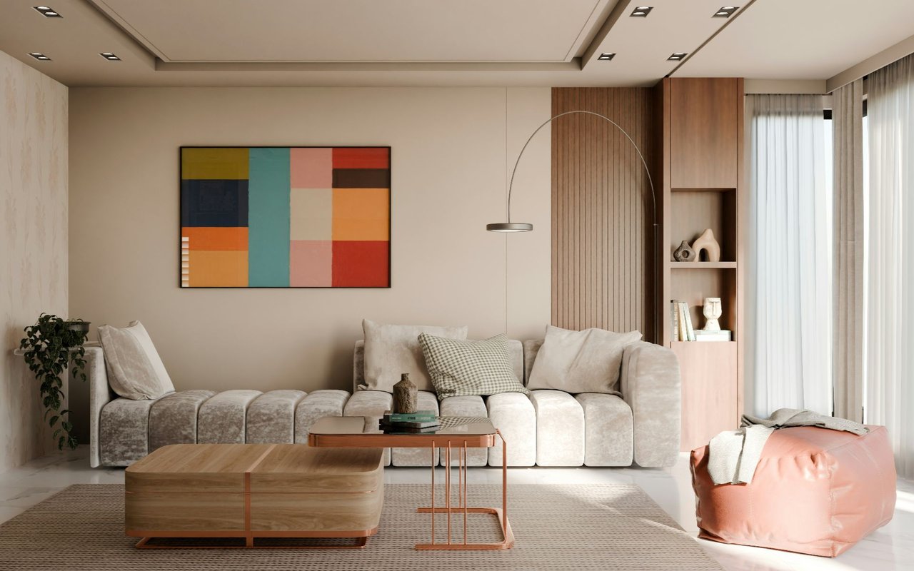 Modern living room with a cream sectional, colorful geometric art, wood cabinetry, and a peach ottoman.