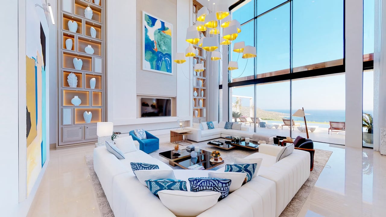 Elegant coastal living room with floor-to-ceiling windows, modern furnishings, and panoramic ocean views in a luxury San Diego home