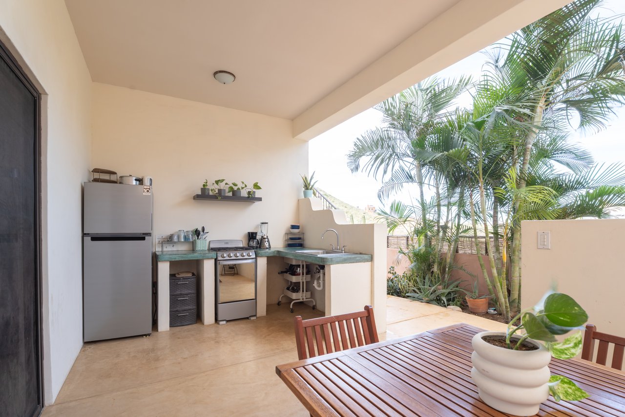 Outdoor kitchen and patio at The Studio House in Villas de Cerritos with terrace seating and garden views in Cerritos, Baja California Sur.