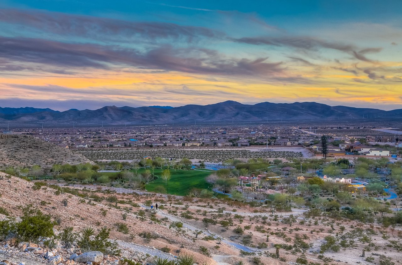 Southwest Las Vegas neighborhoods and desert landscape viewed from Exploration Peak in Mountain’s Edge at sunset