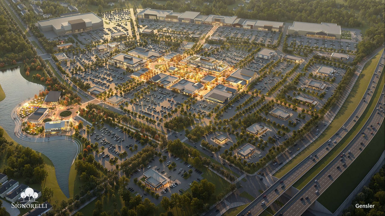Aerial rendering of a retail development with a pond, landscaped walkways, and extensive parking.