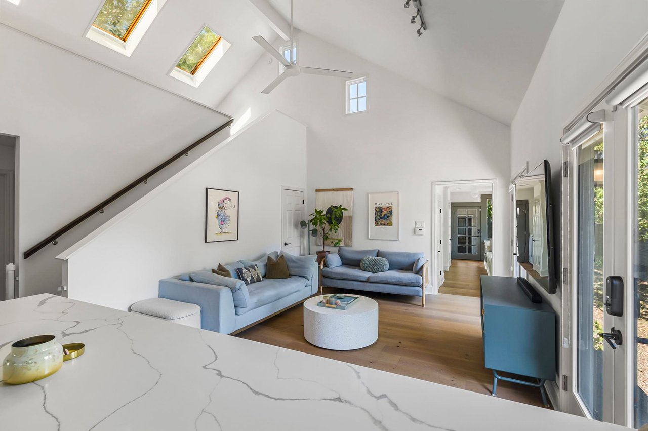 Two-story family room with skylights and vaulted ceiling at 1500 Northwood Rd, Pemberton Heights, Austin. Renovation by McWalters Collaborative.
