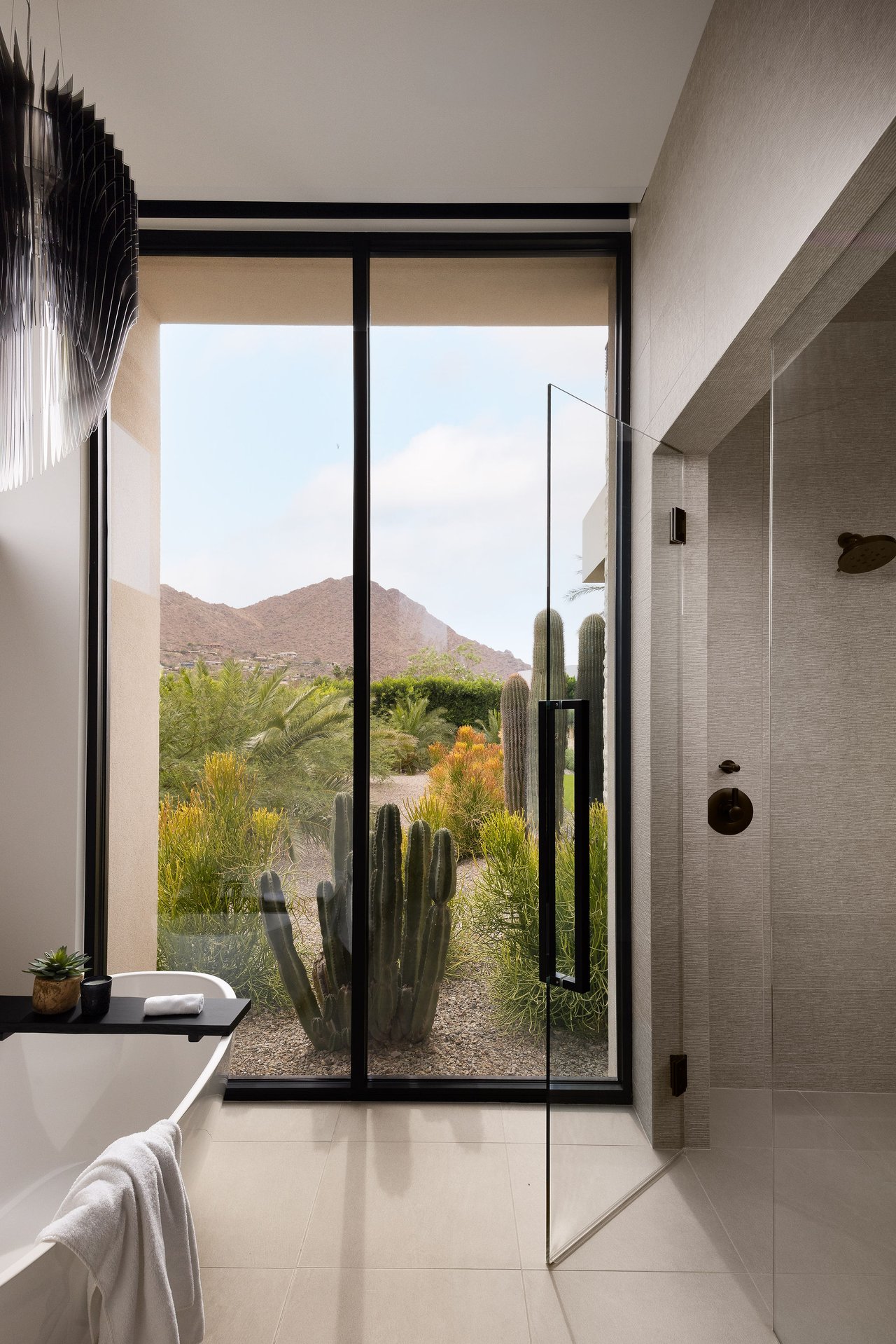 Modern luxury home in Paradise Valley with resort-style backyard, pool, fire feature, and contemporary architecture at sunset.