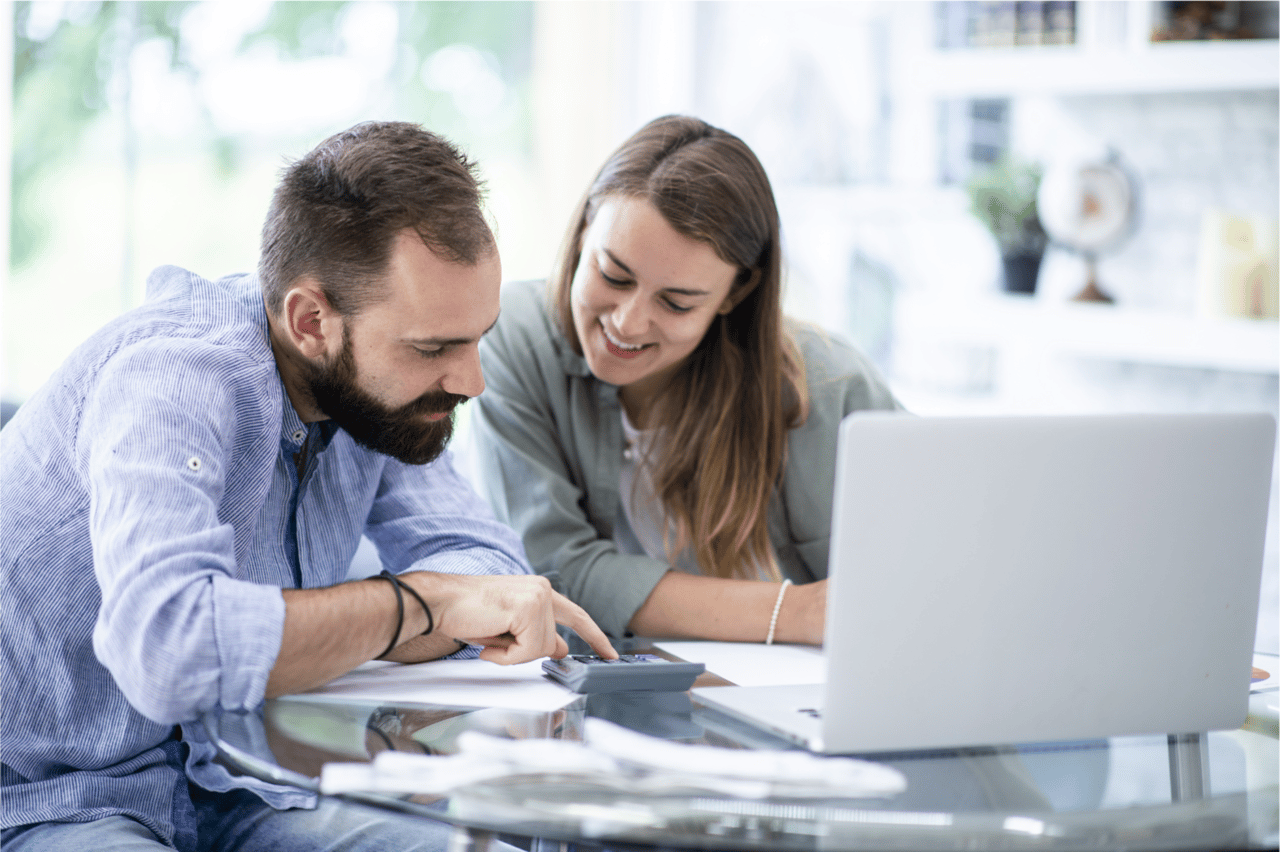 Couple reviewing financial paperwork while preparing for mortgage approval