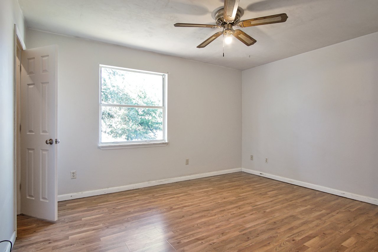 A cozy room featuring a fireplace and elegant hardwood floors, creating a warm and inviting atmosphere.