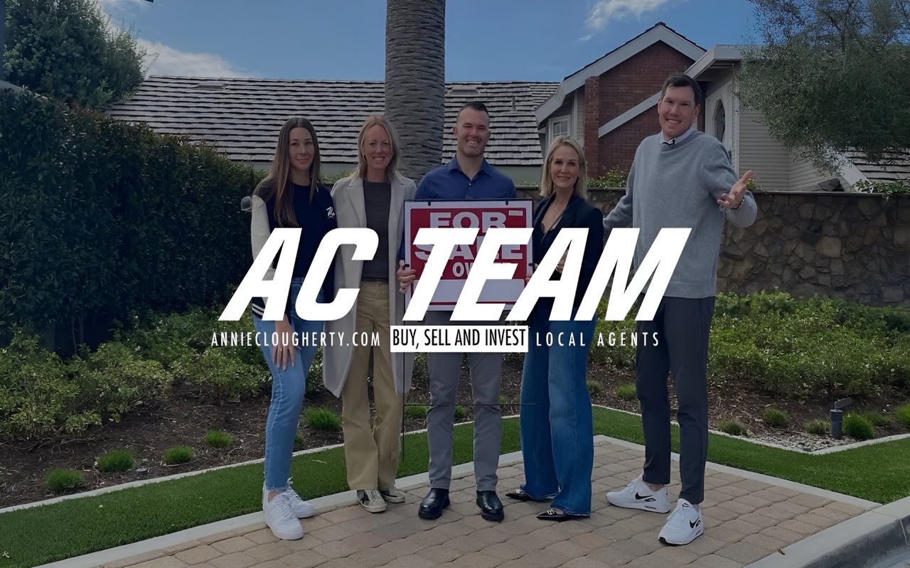  A real estate team of five people, holding a "For Sale" sign, stands together in front of a home with a large logo overlay.