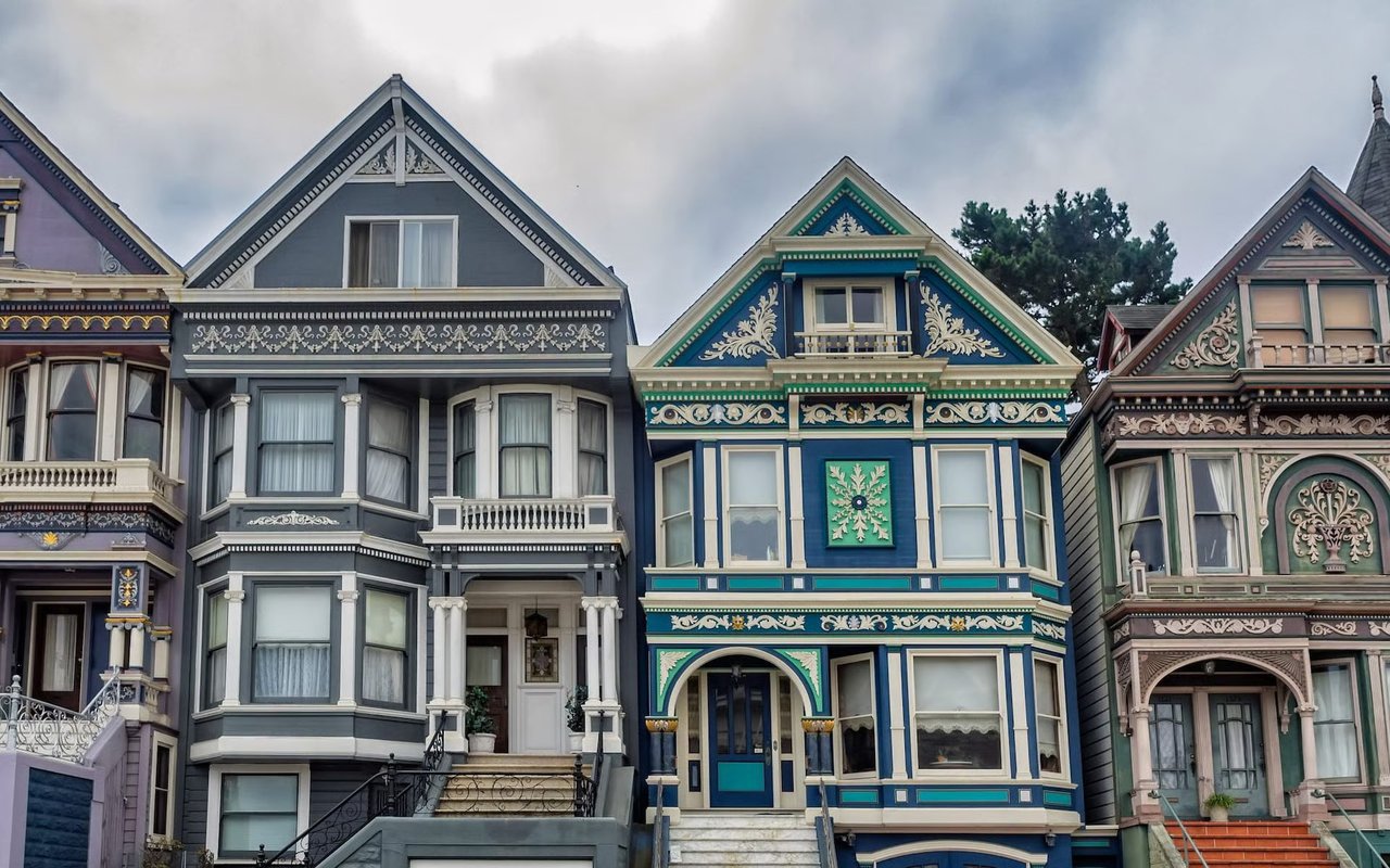 Colorful Victorian homes with ornate trim and steep gables.