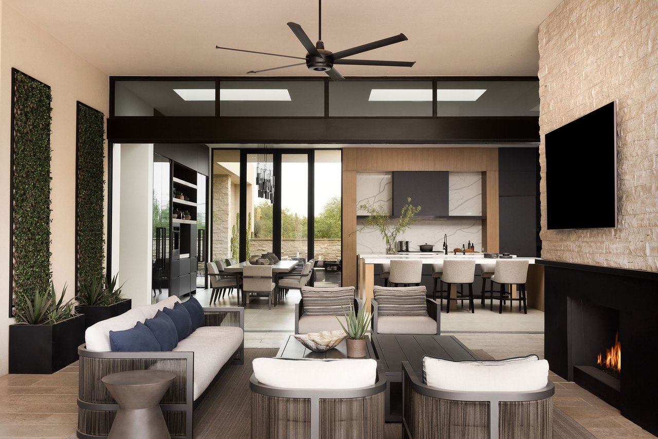 Modern luxury home in Paradise Valley with resort-style backyard, pool, fire feature, and contemporary architecture at sunset.