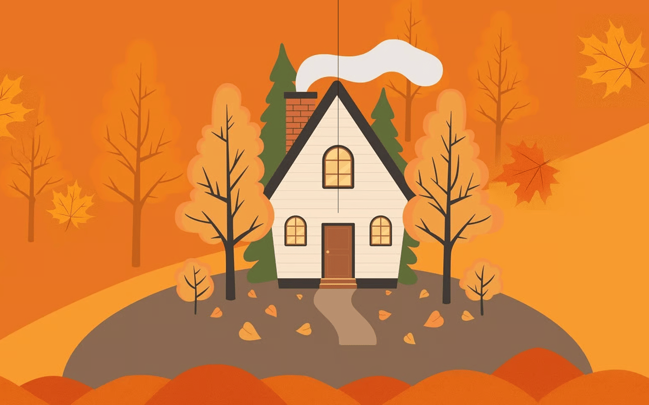 Cream-colored house surrounded by orange autumn trees and fallen leaves