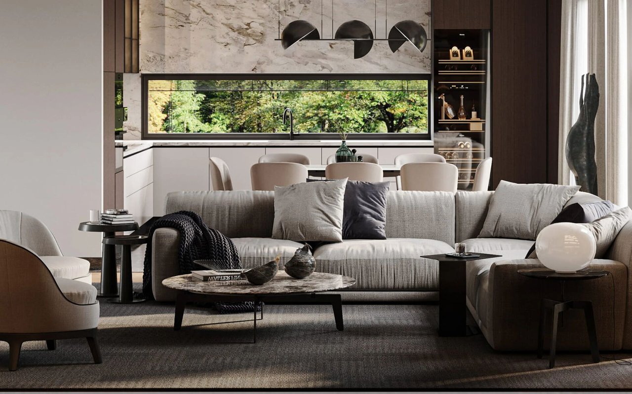 Contemporary living room with a gray sofa, sculptural decor, and a modern kitchen beyond.