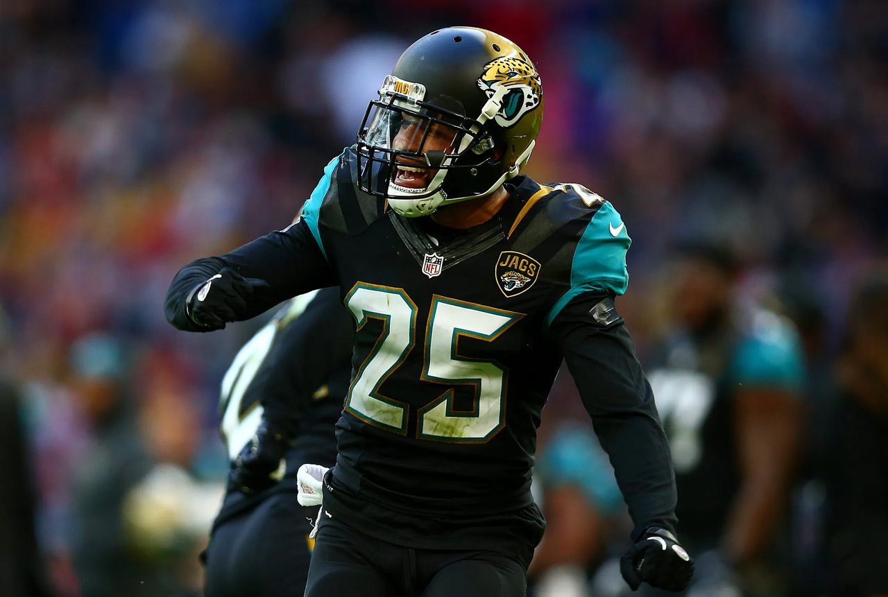 Football player in Jaguars uniform number 25 celebrates on the field.