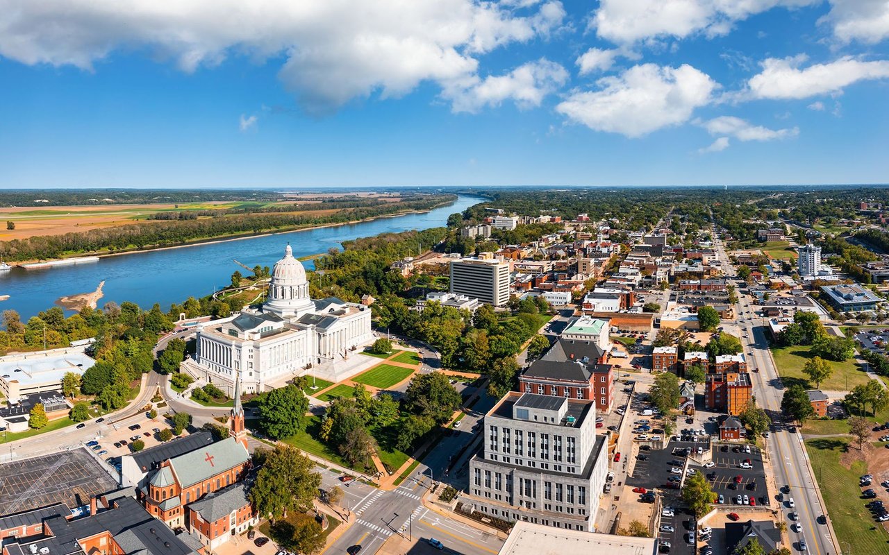 Aerial view of Jefferson City with the Missouri State Capitol beside the Missouri River.