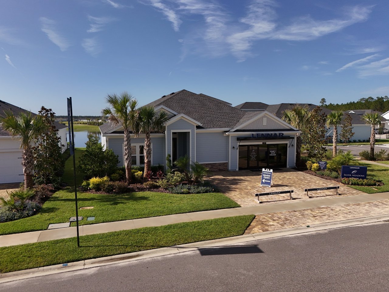Lennar sales center in Silver Meadows with a landscaped entrance and model-home signs.