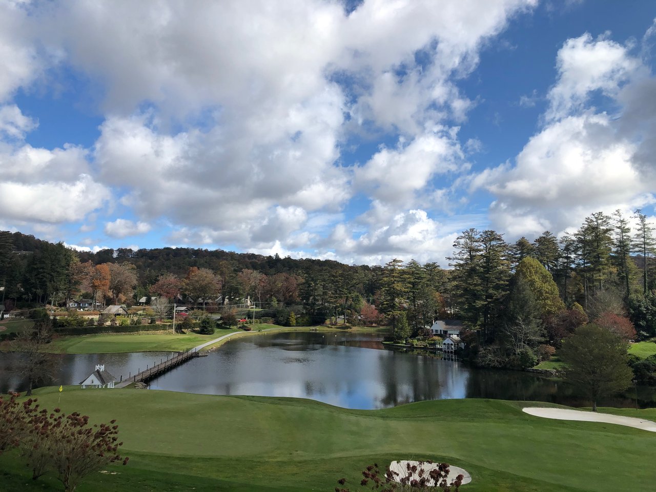Highlands Country Club golf green and lake with a footbridge, gazebo, and fall foliage in Highlands, NC