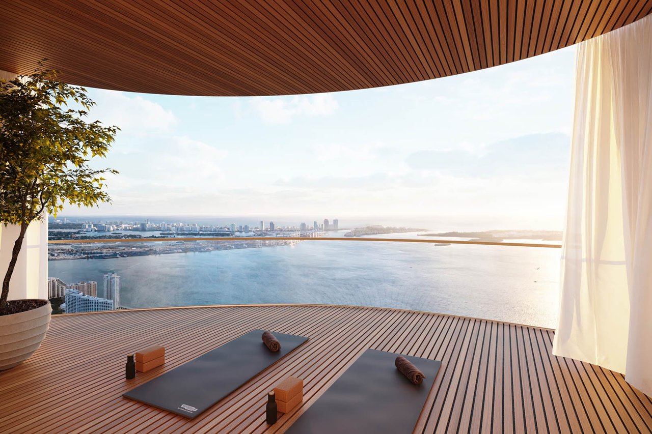 1428 Residences terrace with yoga mats overlooking the water and Miami skyline.