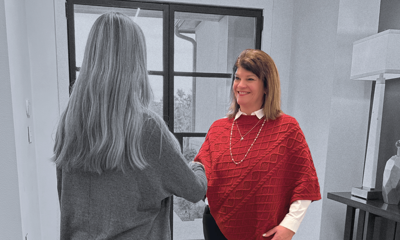 Photo of Lisa Little with client in a local Hill Country neighborhood, showcasing their commitment to the community.